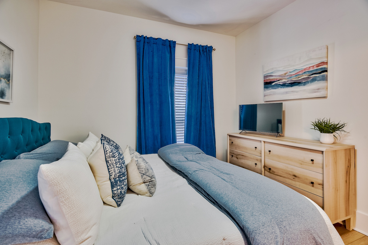 Bedroom with dresser and television