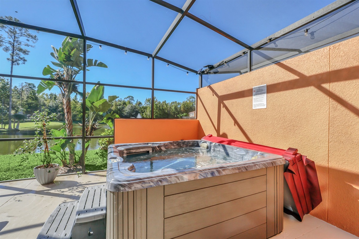 Private covered lanai with seating area, hot tub and lounge chairs