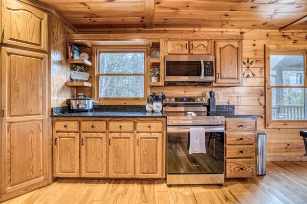 Fully stocked kitchen with low tox features like reverse osmosis water filter under the kitchen sink and attached to the fridge water, stainless steel pots and pans, glass and ceramic bakeware, stainless and silicone cooking utensils, and more!