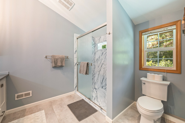 Bathroom #1 of 2: upstairs primary bathroom with walk-in shower