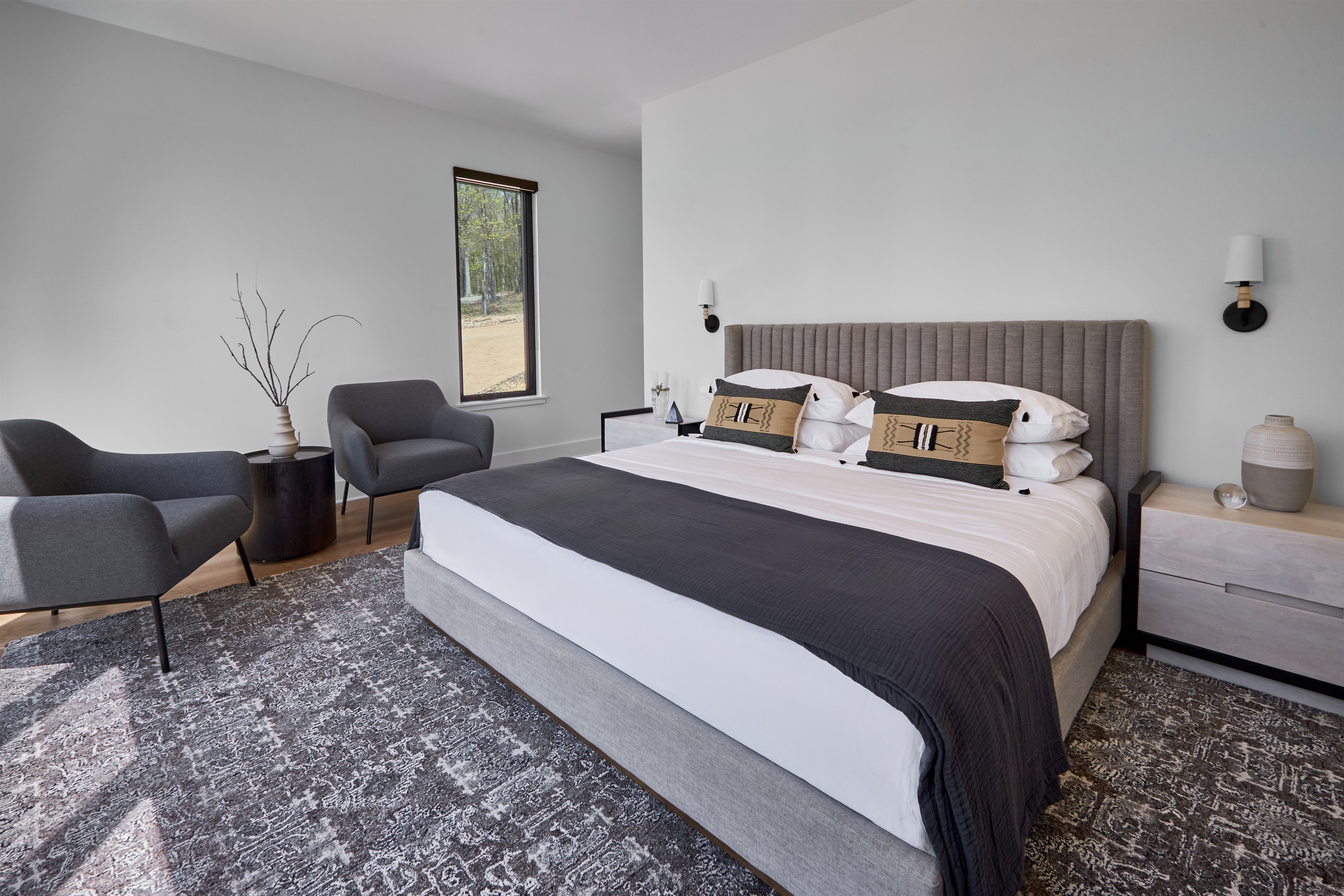 Wake up surrounded by nature in this stylish king suite with floor-to-ceiling views of the wooded landscape.