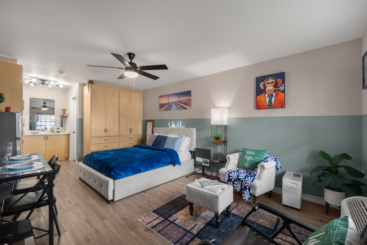 Studio space with a queen bed, twin pull-out bed, kitchenette, dining spot, and sitting area.
