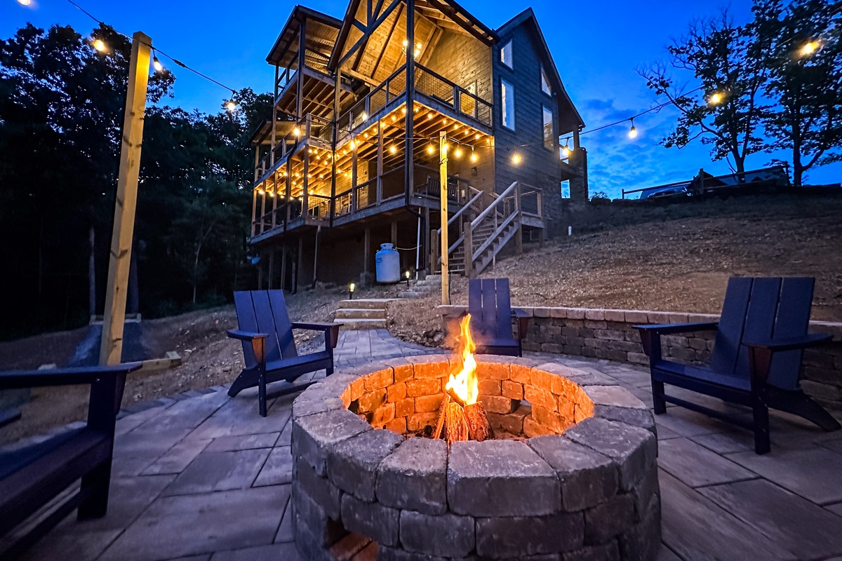 Parks Lodge has a large fire pit that's surrounded by string lights and Adirondack chairs. 