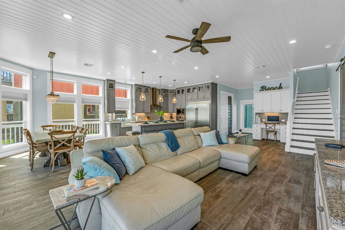 Crystal Paradise Living Room: Spacious living room with abundant natural light and an inviting open layout. The middle of the couch has power operated reclining. The remotes are inside on the side of the seat cushion. 