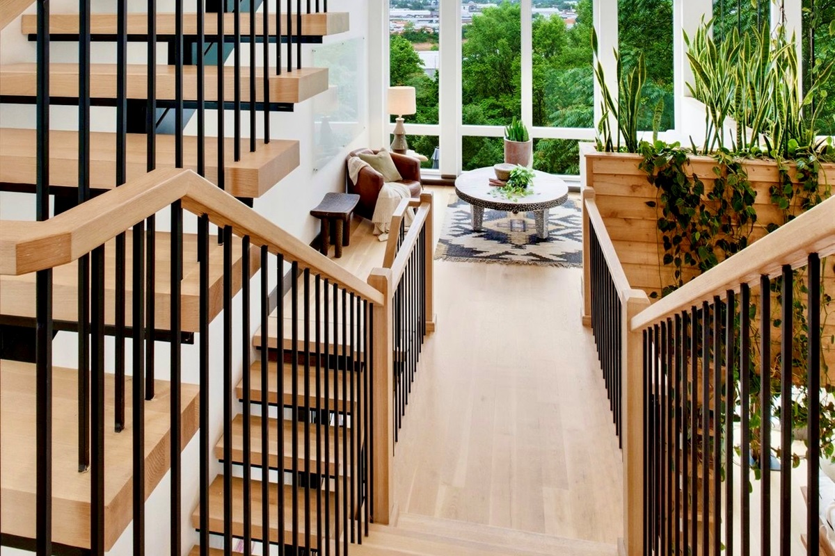 Sleek open staircase w/ wood treads & black railings — sculptural details at every turn.
