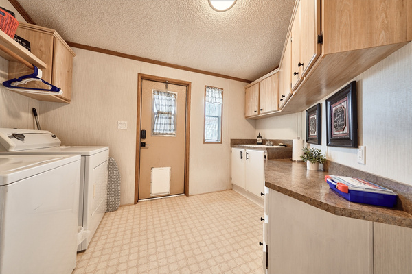 Laundry Room includes Washer, Dryer, Iron, Ironing Board, Detergent, Dryer Sheets and Large Utility Sink