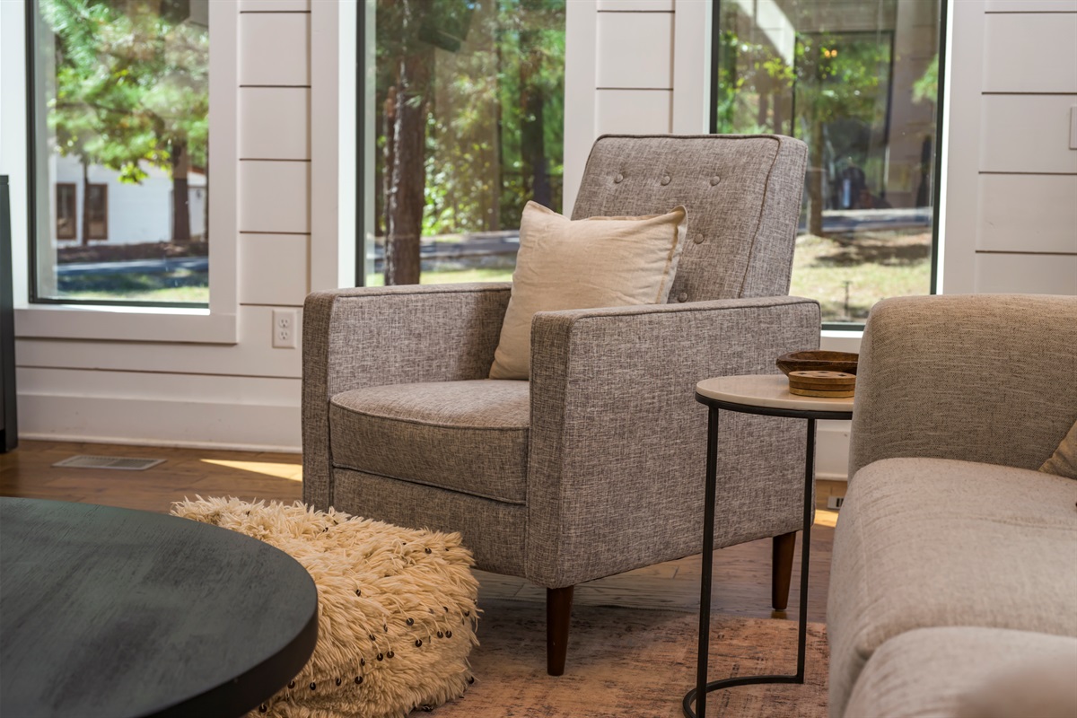 A cozy reading corner with forest views—perfect for slow mornings and quiet moments at our Broken Bow cabin