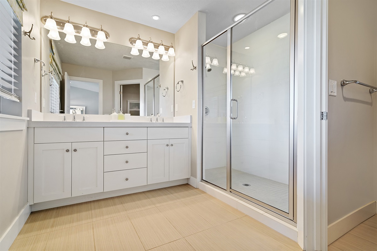 Luxurious primary bathroom with bidet. double vanity, and a walk-in shower.