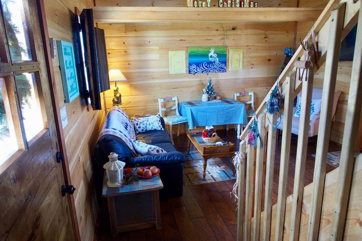 Living Room Area with Stairs to Open Air Loft