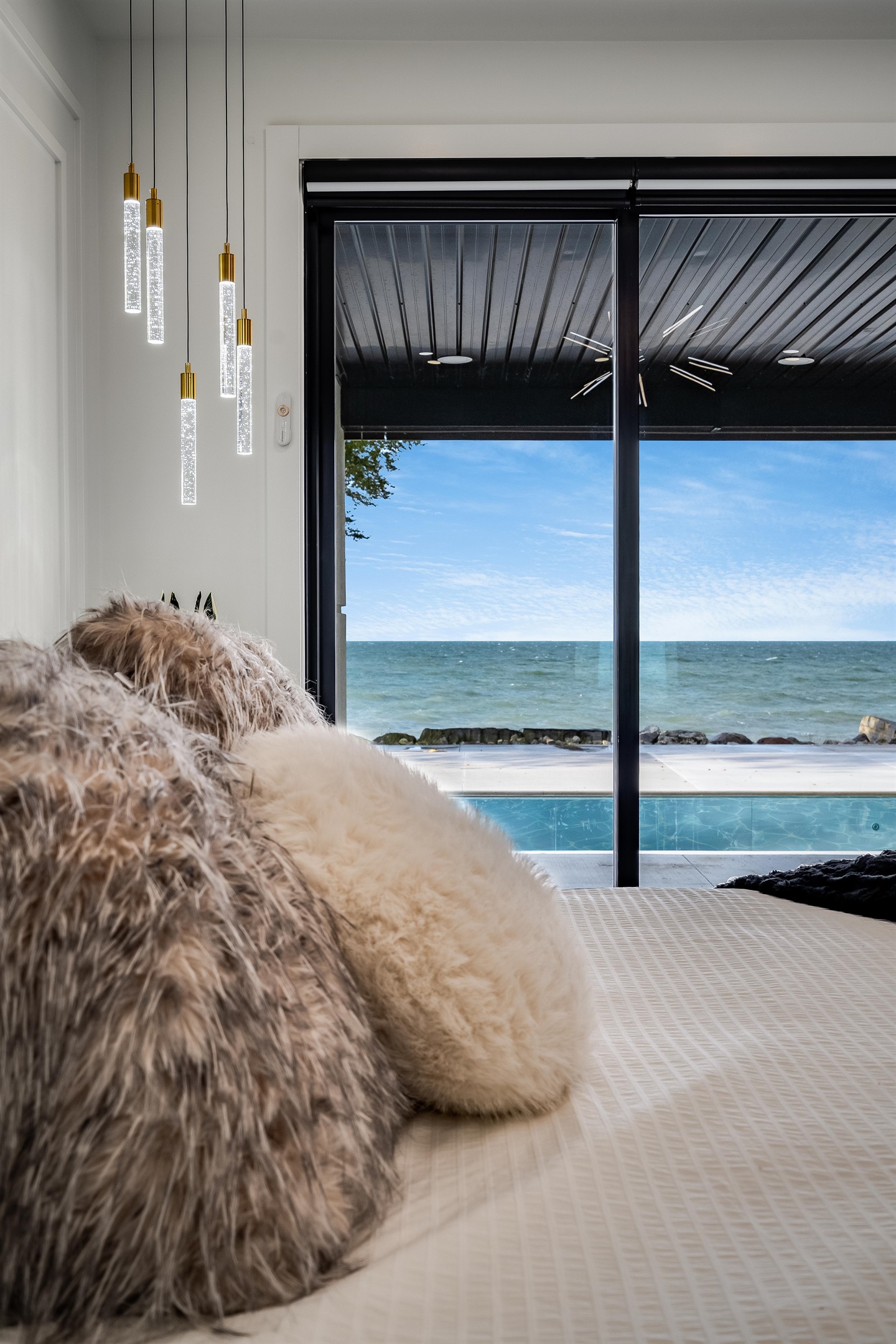 King Bedroom with Premier Master Suite on the main floor with patio access and lake views.