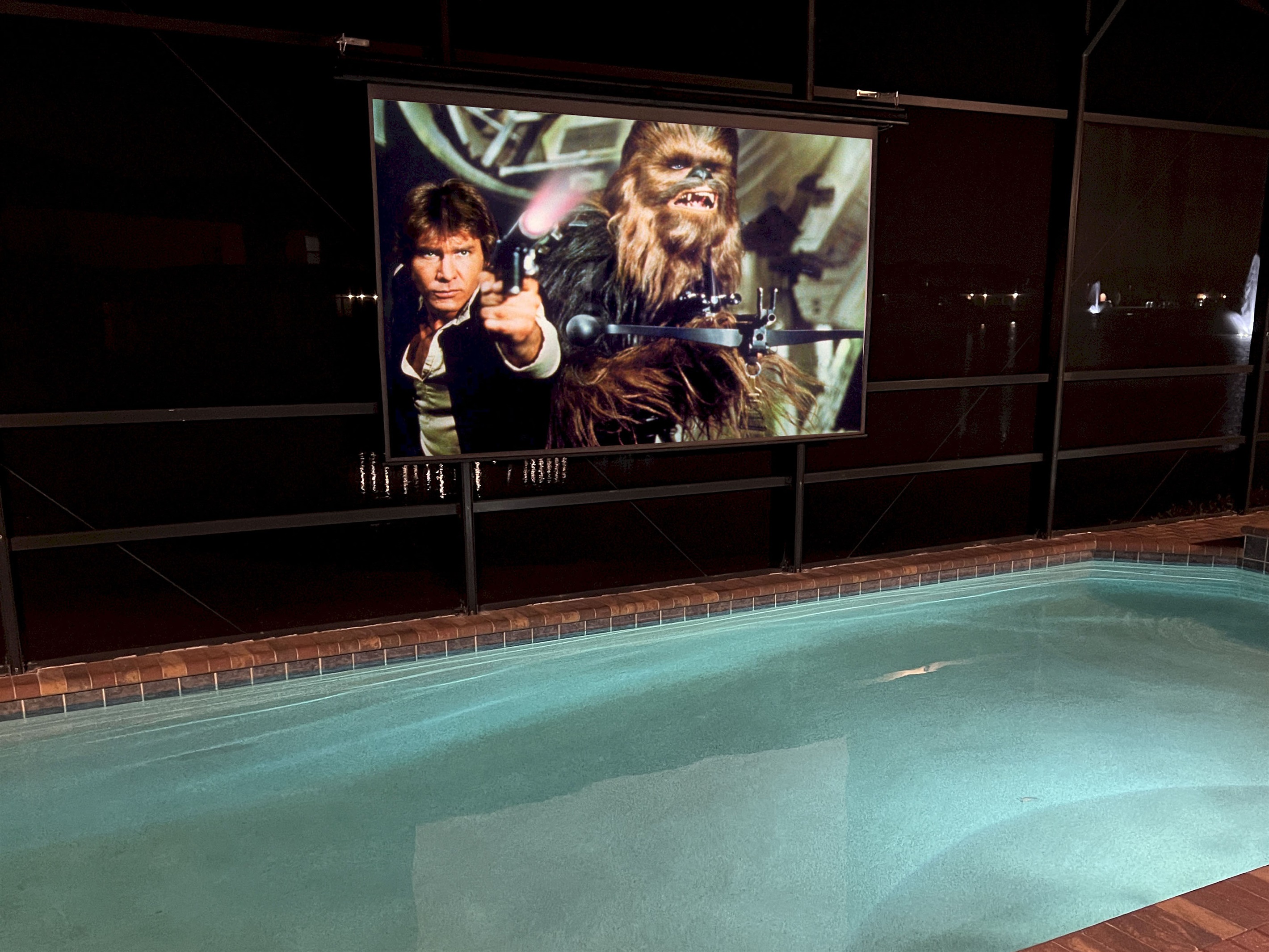 Enjoy Movies And TV At Night In The Poolside Theater
