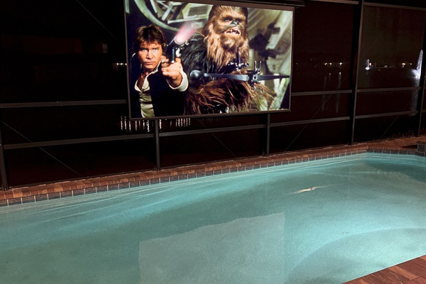 Enjoy Movies And TV At Night In The Poolside Theater