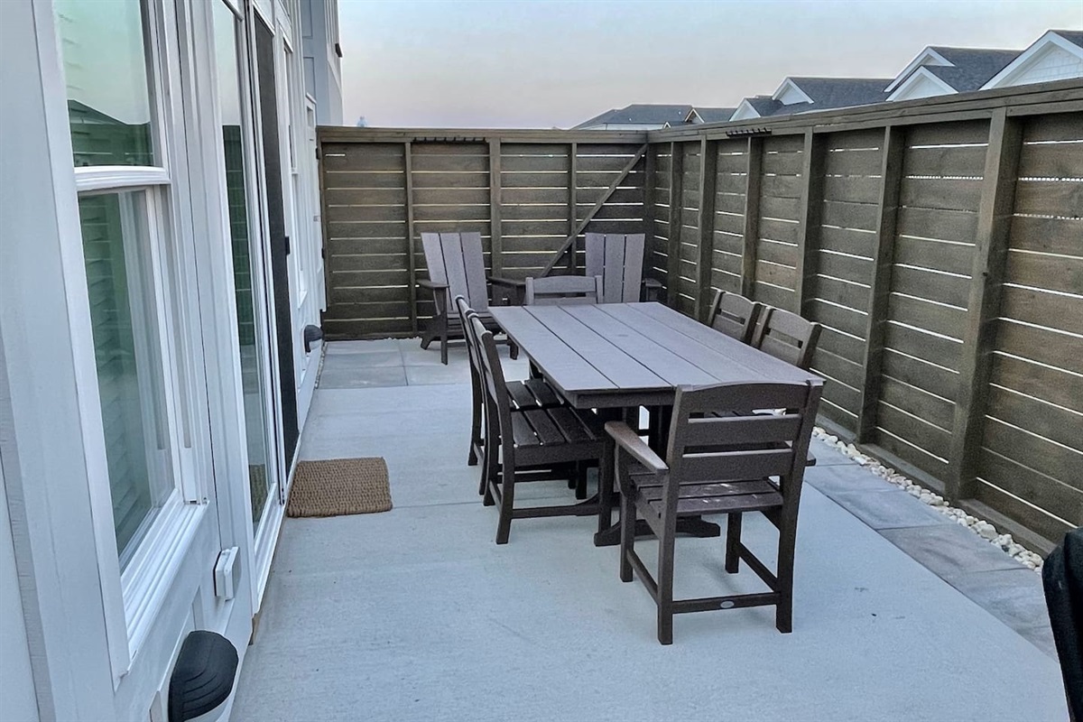 The patio includes an outdoor shower, making it easy to rinse off the sand after a day at the beach before heading inside.