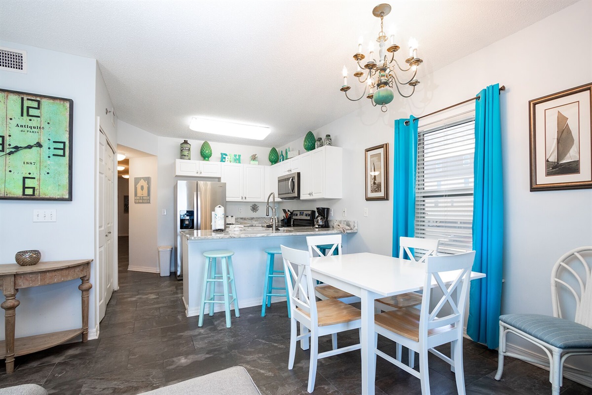 Dining area with seating for 4 at the table and 3 at the bar