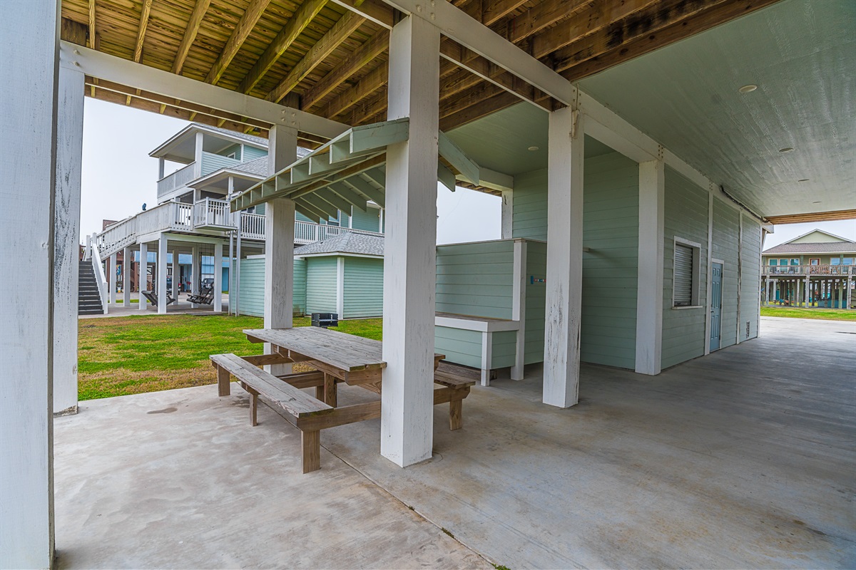 Patio with picnic table seating and enclosed outdoor shower.