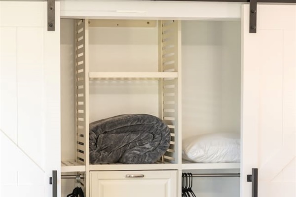 With designated space for hanging garments and folded essentials, this open closet setup keeps things minimal and tidy.

