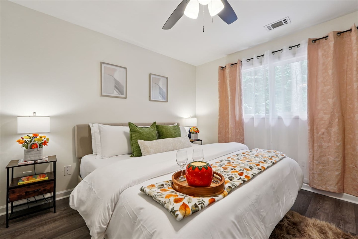 Master bedroom featuring a comfortable king bed and an Amazon Fire-powered Smart TV. The shared bathroom is conveniently right next door. This room includes 2 full-body towels, 2 washcloths, and 2 hand towels for your stay.