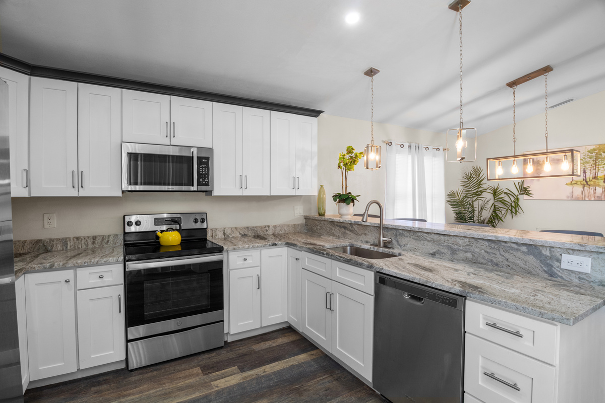 Bright and modern kitchen featuring sleek white cabinetry.