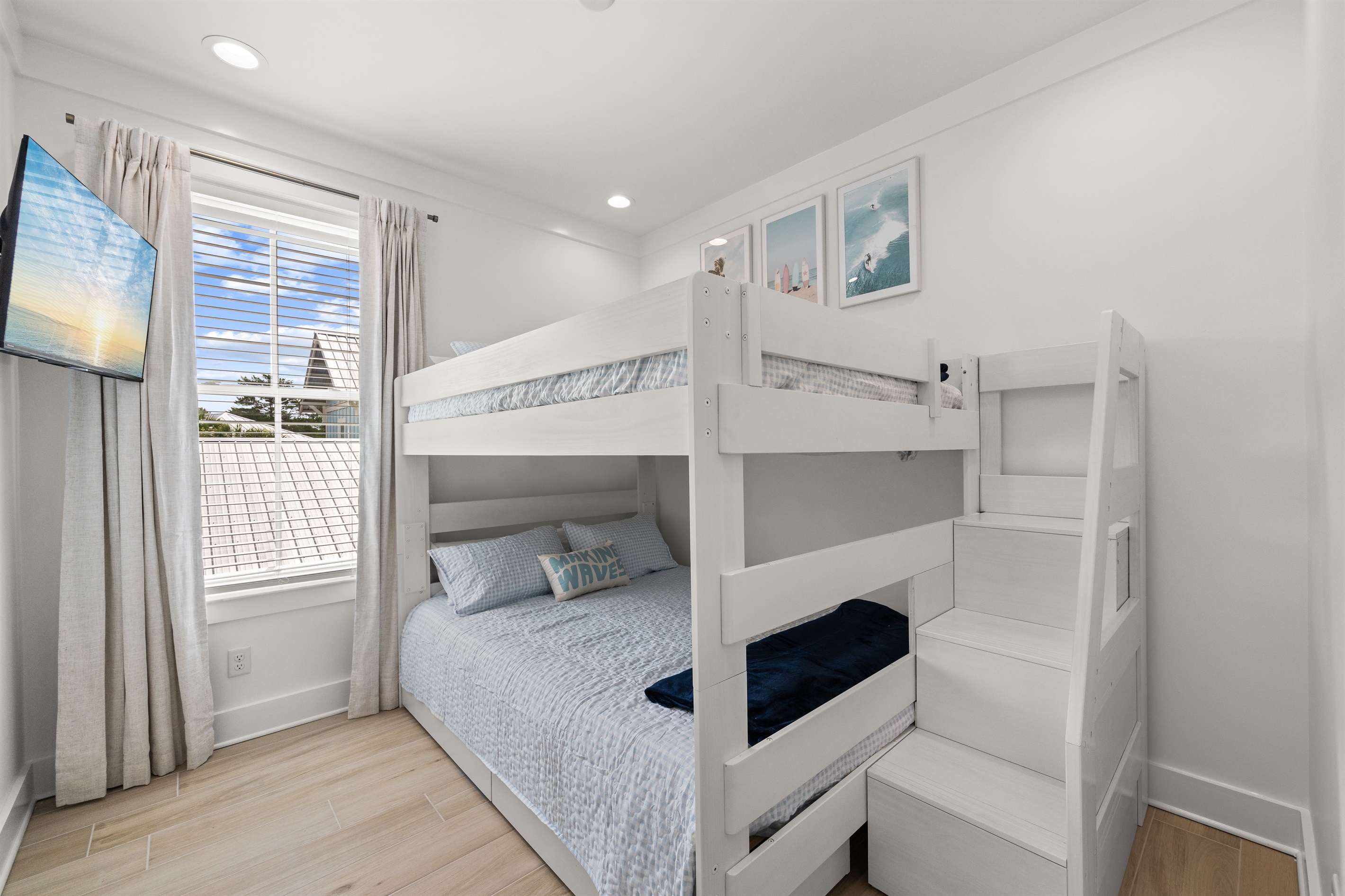 Perfect for families and groups, this bright bunk room features queen-over-queen bunks and a relaxed coastal design, offering plenty of comfortable sleeping space after a day at the beach.