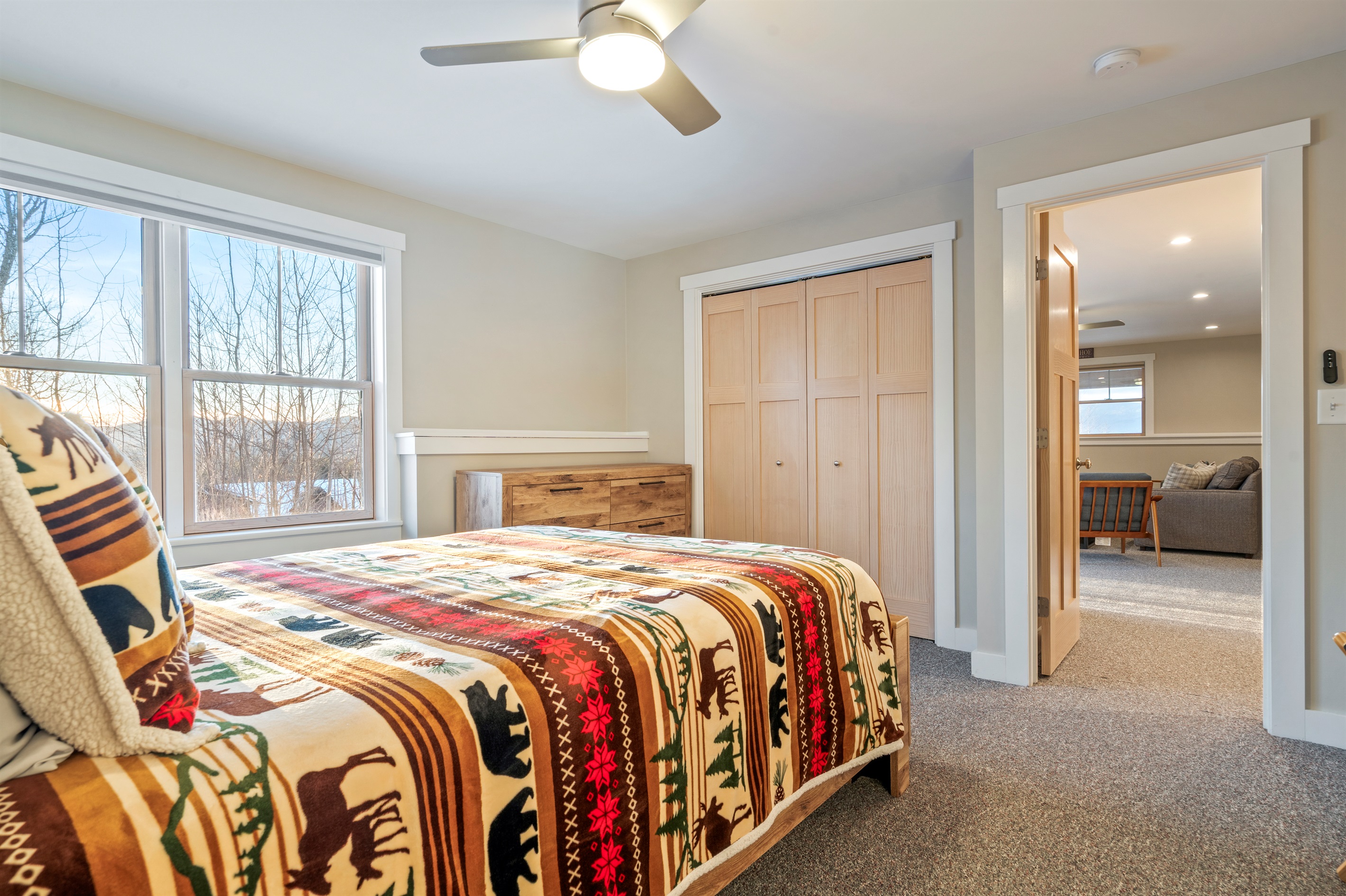 Relax in the basement bedroom with a cozy queen bed and added privacy.