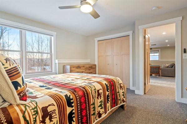Relax in the basement bedroom with a cozy queen bed and added privacy.