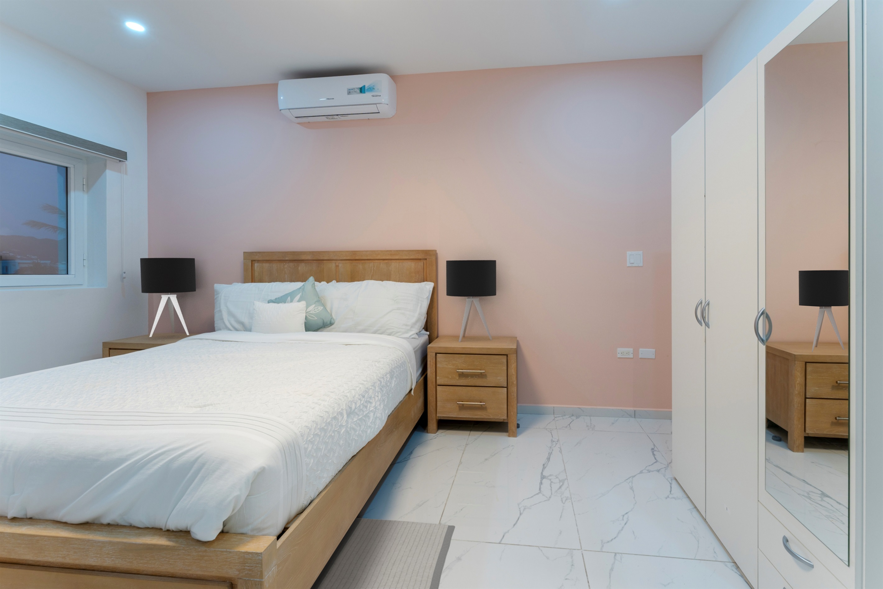 Second bedroom with queen bed, storage drawers and mirrored wardrobe