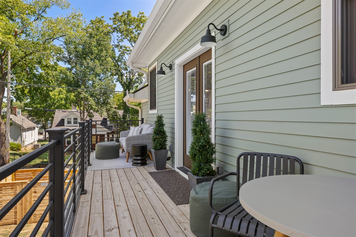 Spacious balcony with seating for dining or lounging.