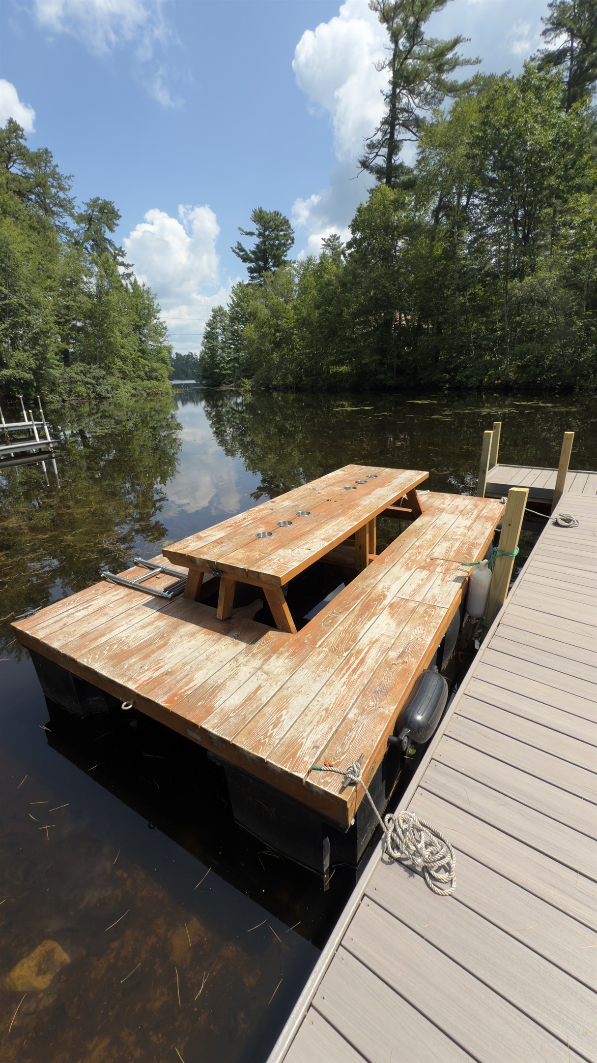 Waterfront Dock: Enjoy your private, sun-soaked afternoons at the charming picnic table boat overlooking the water!