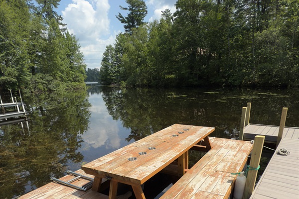 Waterfront Dock: Enjoy your private, sun-soaked afternoons at the charming picnic table boat overlooking the water!