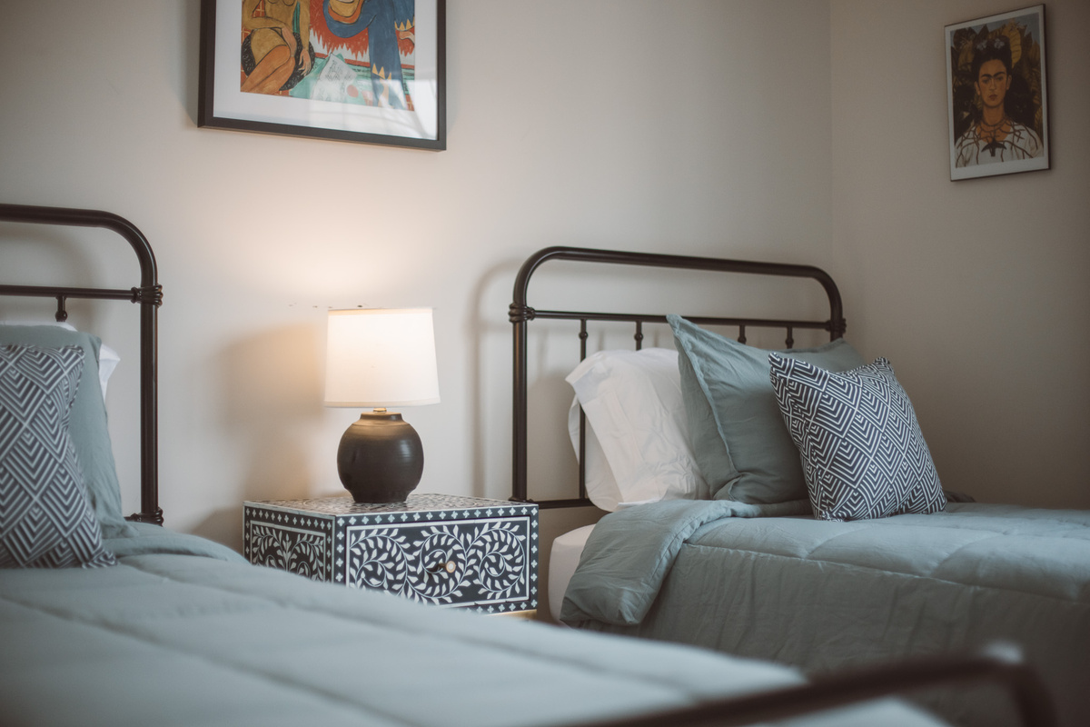Sunny guest bedroom with smart TV.