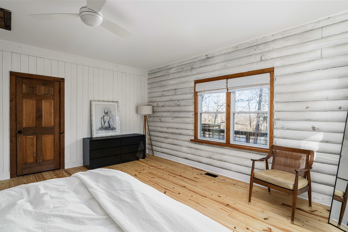 Bedroom 1: Bright and airy retreat with modern decor and picturesque woodland views!