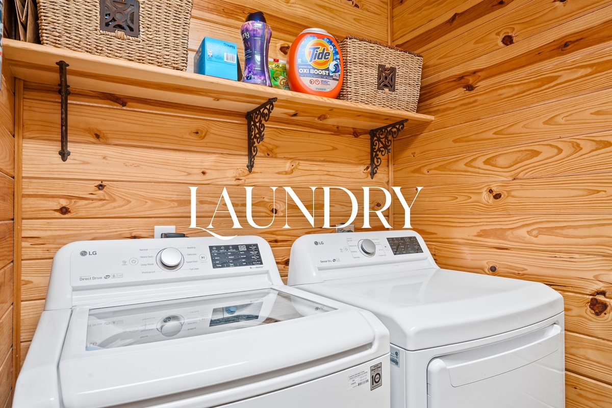 Laundry area with washer, dryer, and shelving for easy mid-stay cleaning and convenience.