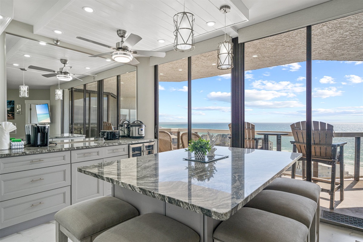 Most kitchens have a window. This one has the entire Gulf Coast. Premium finishes, generous counter space, and the emerald Gulf waiting just beyond the open doors every single time you walk in.