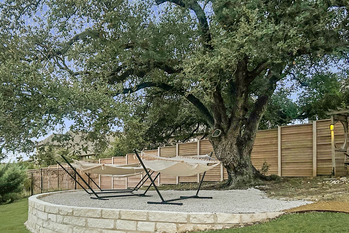 "Embrace tranquility on our large platform featuring four cozy hammocks nestled under a magnificent 100+ year-old oak tree. It's the perfect spot to relax, unwind, and soak in the serene surro