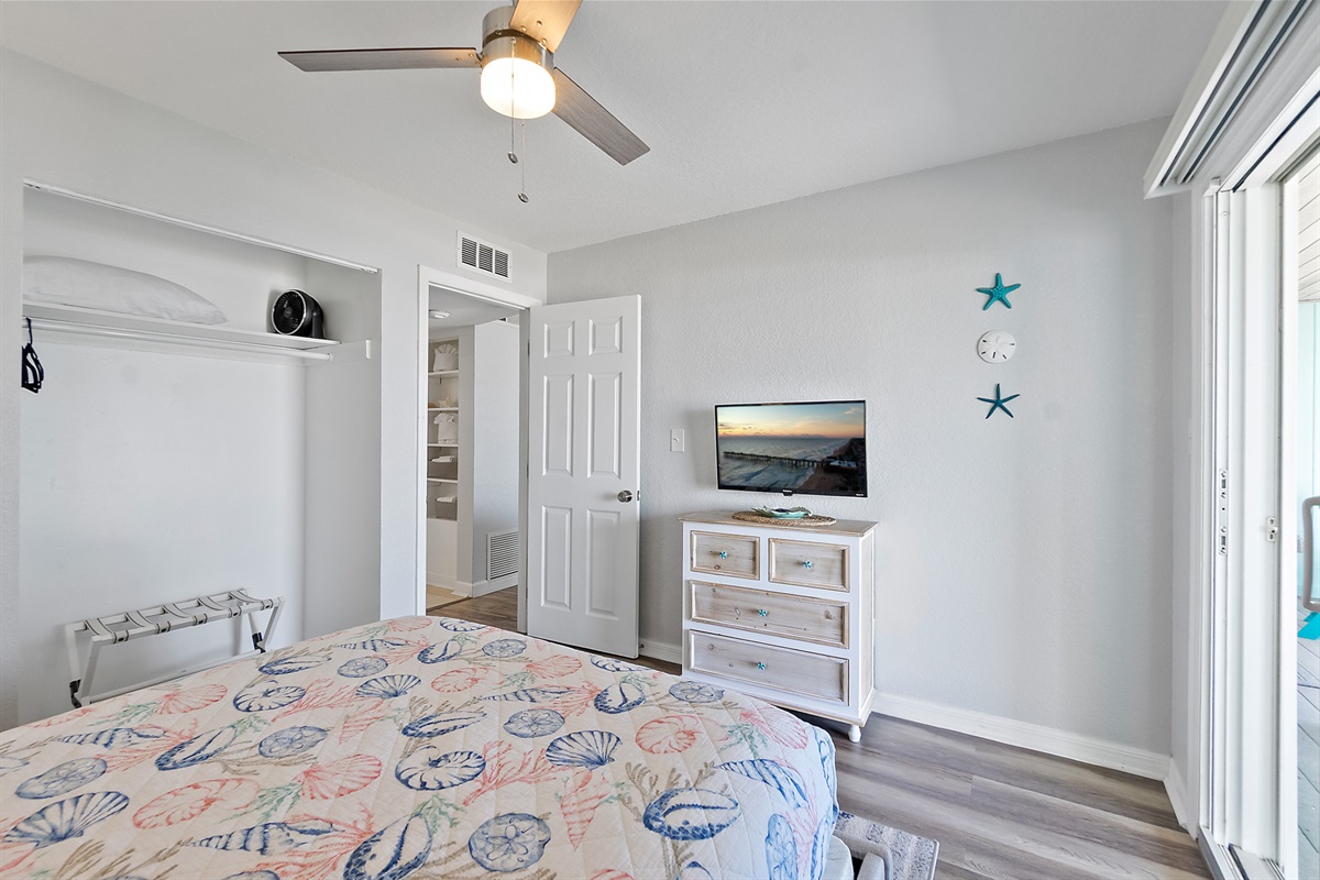 Peaceful bedroom retreat with smart TV and ocean breeze