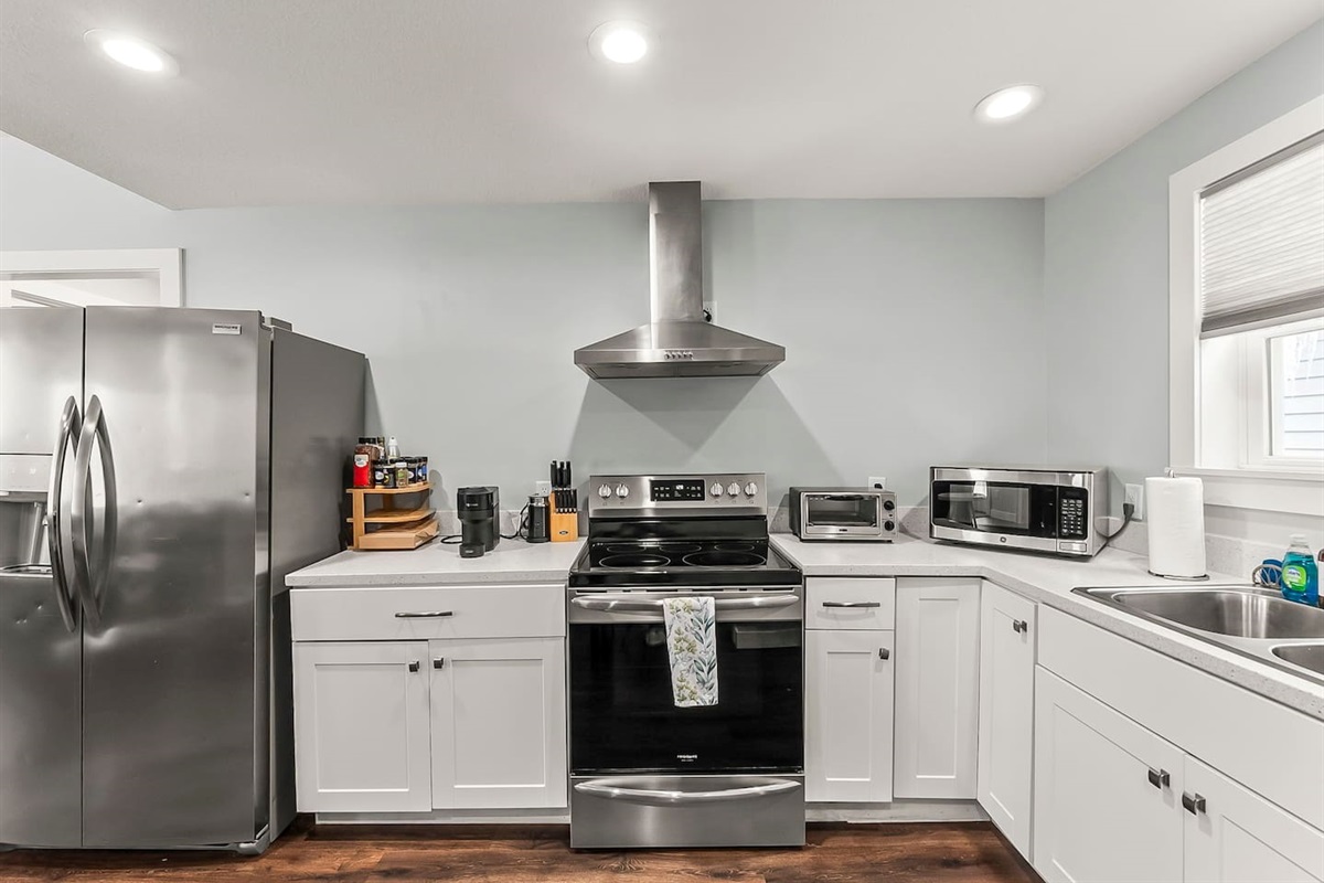 Thoughtfully designed kitchen with updated appliances, clean countertops, and an inviting layout that flows into the living space.