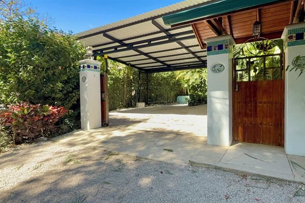 Electric car gate. Covered parking for two cars and a quad or golf cart