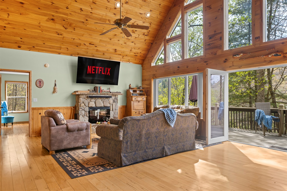 Living Area: Enjoy sunlit views and movie nights in this stylish, nature-inspired gathering space!