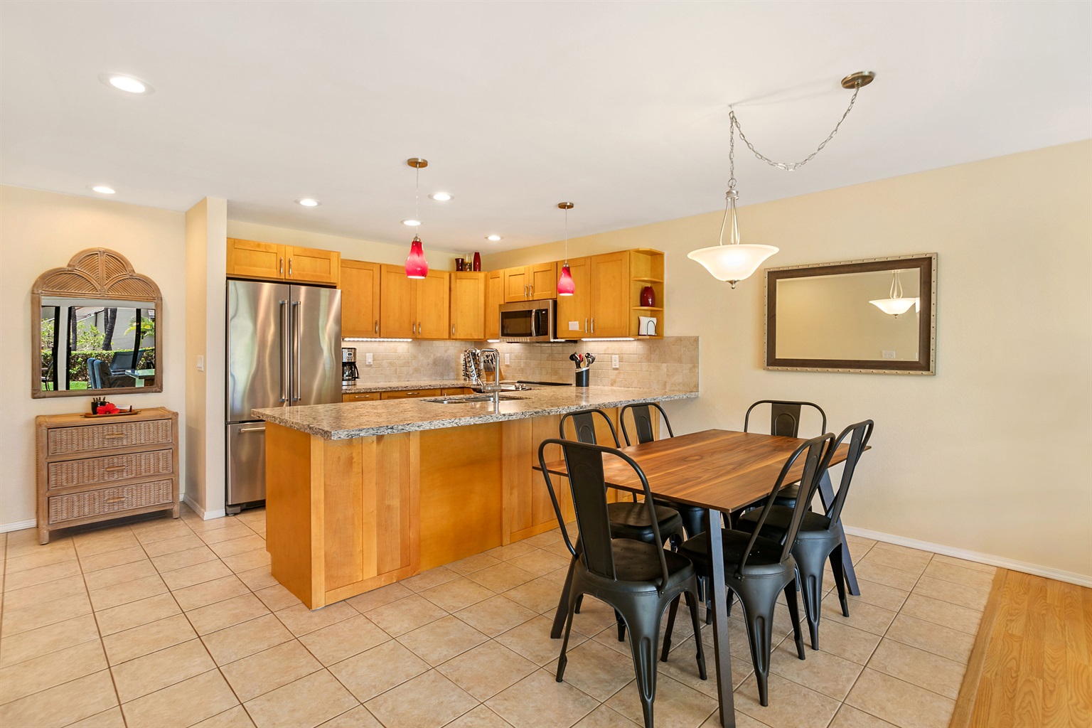 Another look at the kitchen and dining table - stainless appliances, spices, and a Vitamix!