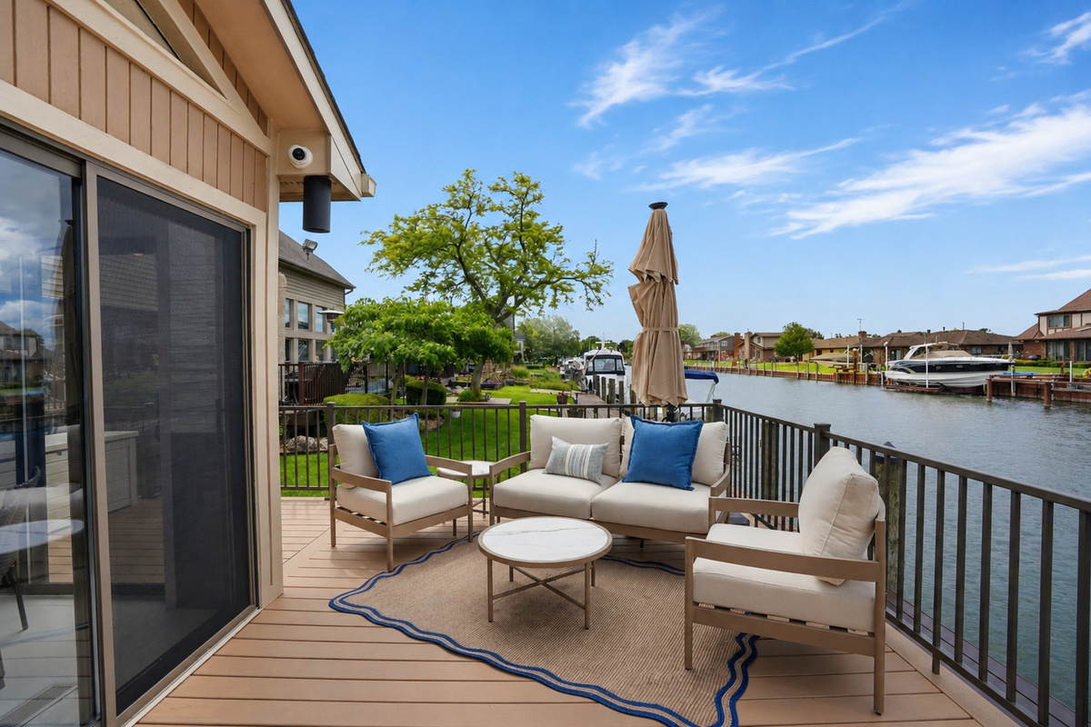 Outdoor lounge seating on a private waterfront deck with canal views. Relaxed, resort-style space perfect for entertaining, enjoying sunsets, and unwinding by the water.