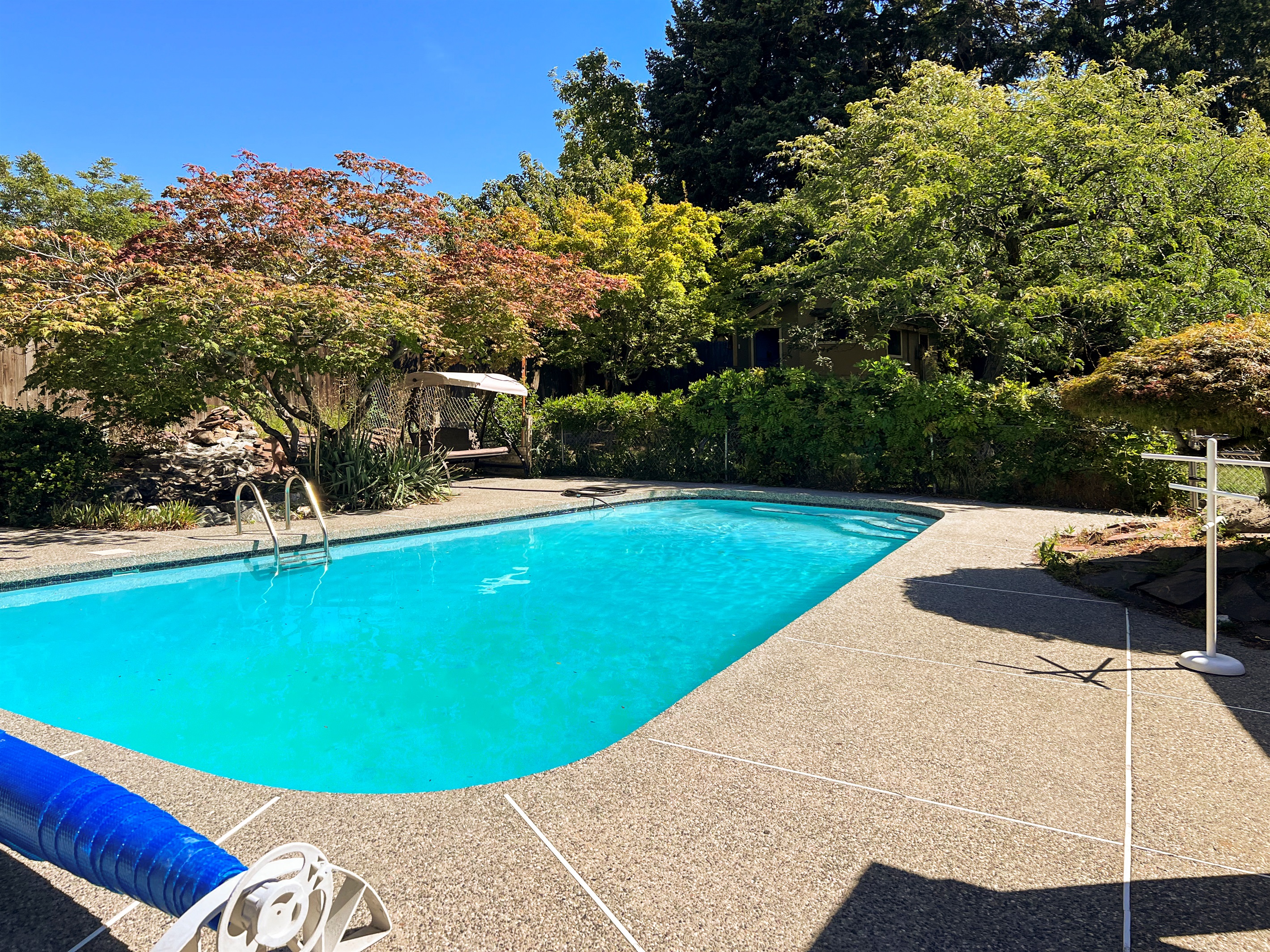 In ground swimming pool in private backyard.