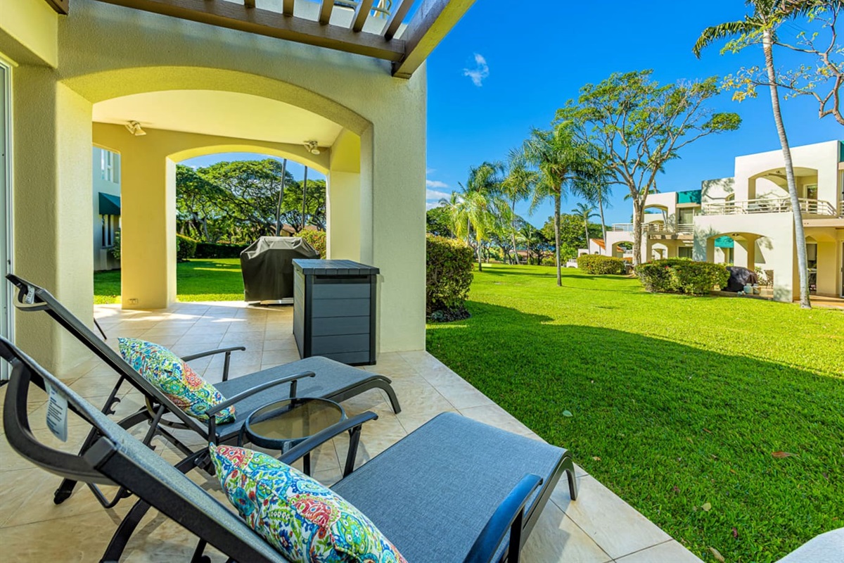 view from the chaise lounges onto a large lawn (behind you is the sliding door to the bedroom). Note the BBQ has been removed from all lanais in May 2024. There are now common BBQ areas around the property