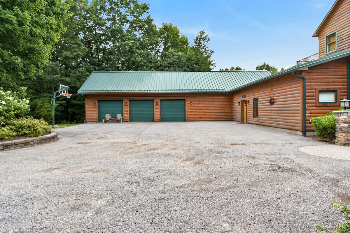 Long wooden home with gravel parking