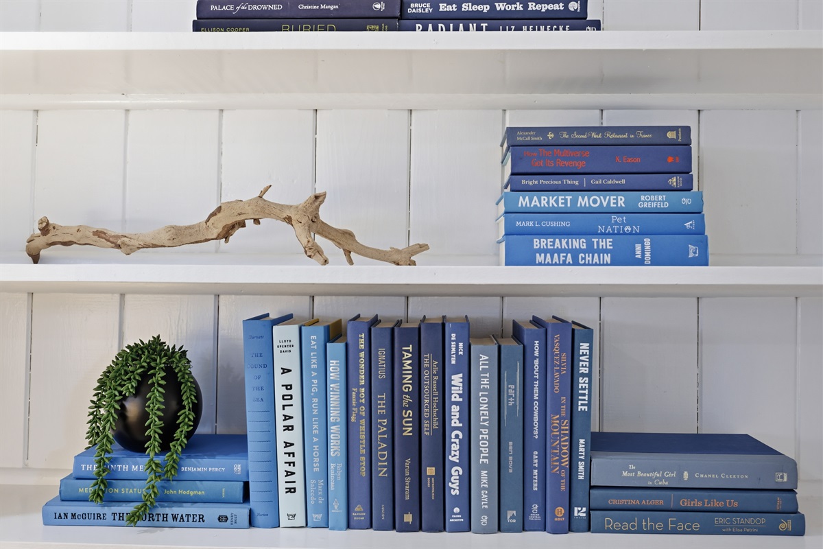 Thoughtful design touches throughout &mdash; curated coastal books + decor details.