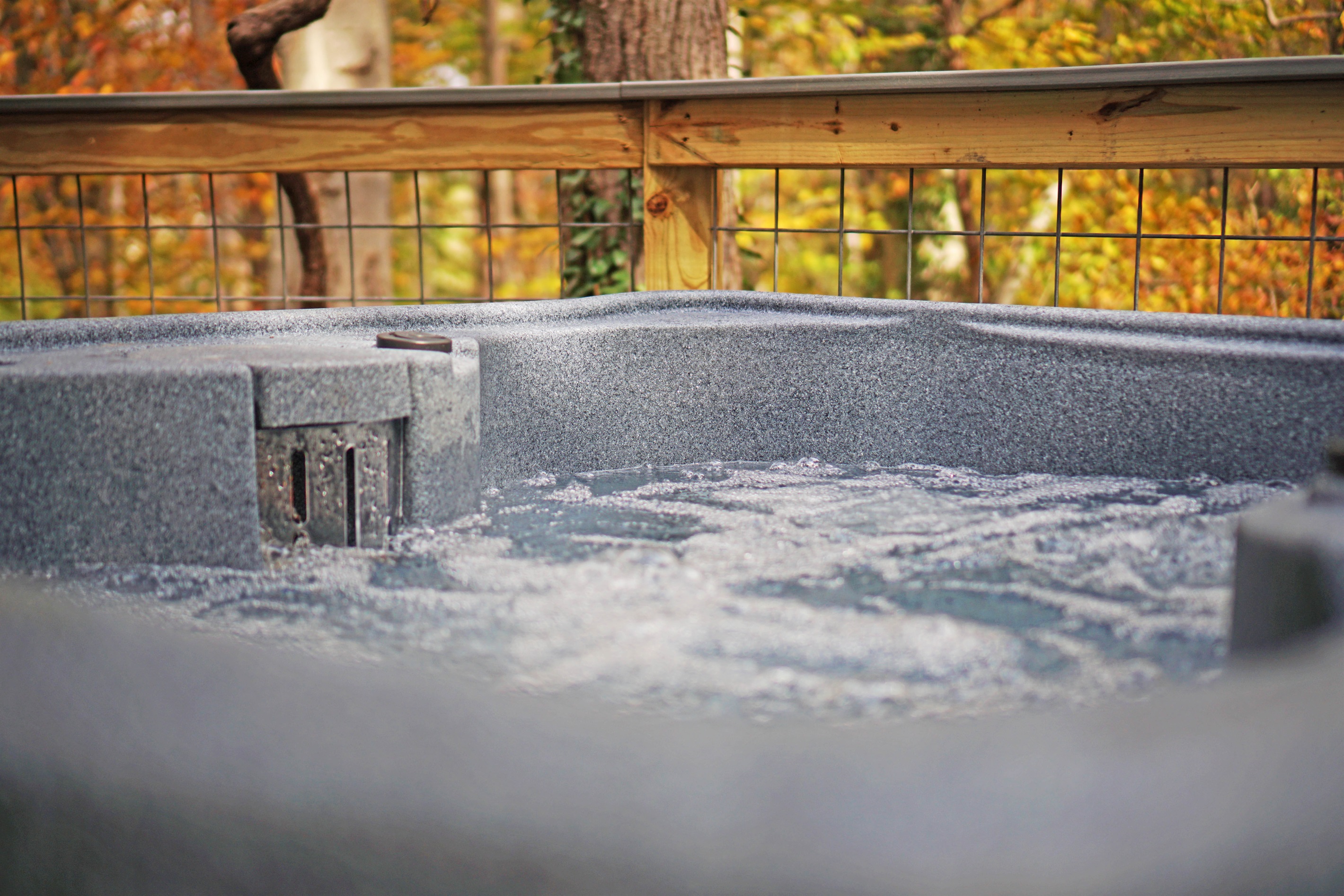 Soak your cares away in this bubbling hot tub, surrounded by the beauty of nature's.