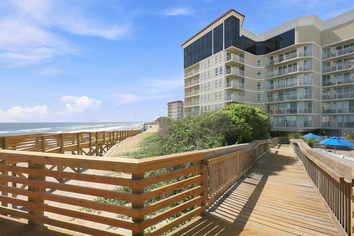 Follow this wooden walkway directly from the building grounds out toward the coastal shoreline.