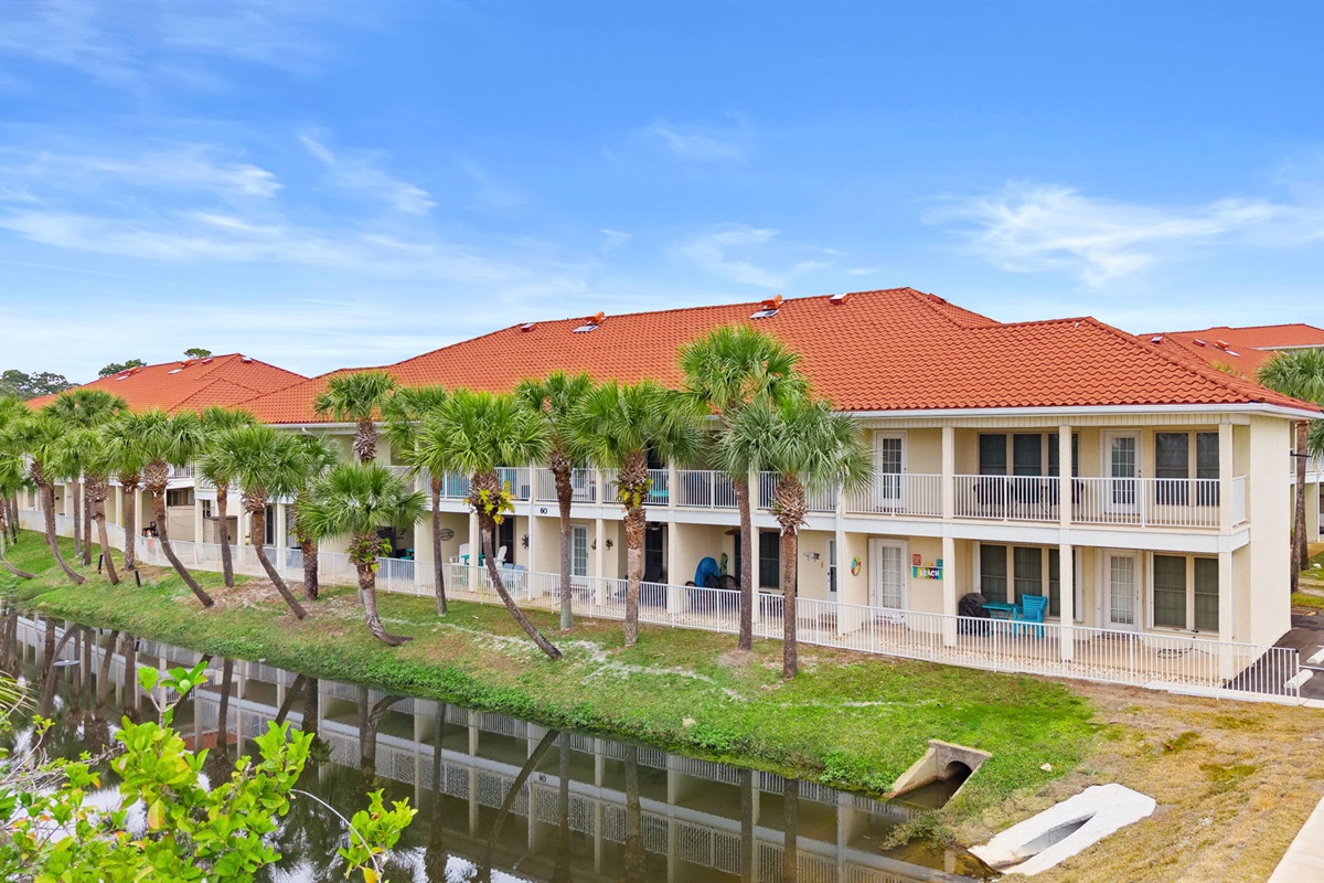 First-floor patio with peaceful lagoon views — perfect for morning coffee or evening unwinding. Quick, easy 2-minute stroll to beach access via sidewalk right out of your back door!