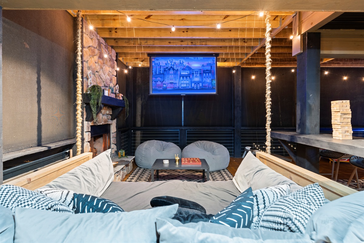 Cozy seating on the queen-size swing-bed and projector make this outdoor spot magical.