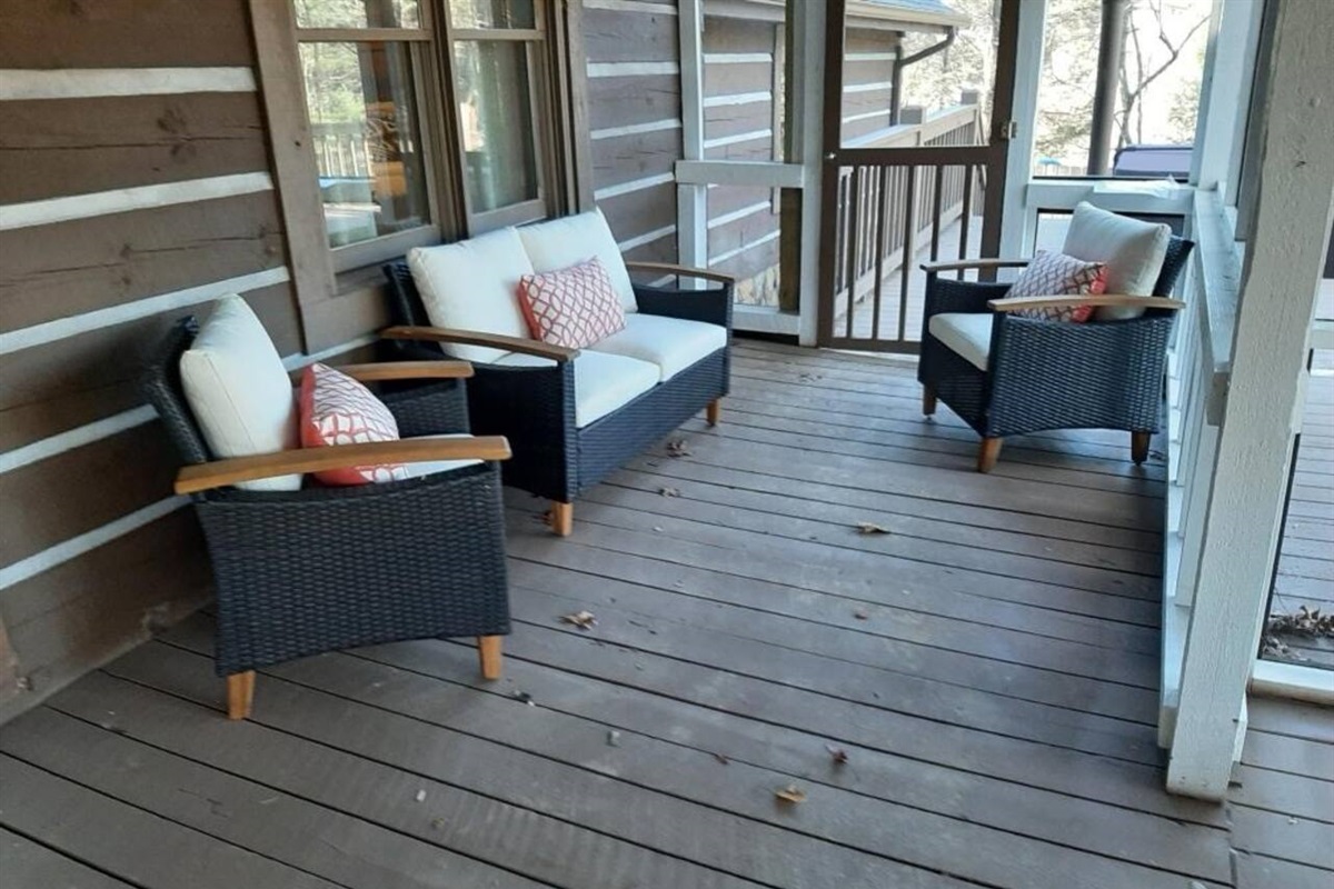 This is one of the outdoor seating areas that is covered and screened in.  This is part of the large cabin and joined to the deck with hot tub, grill, and fire pit.