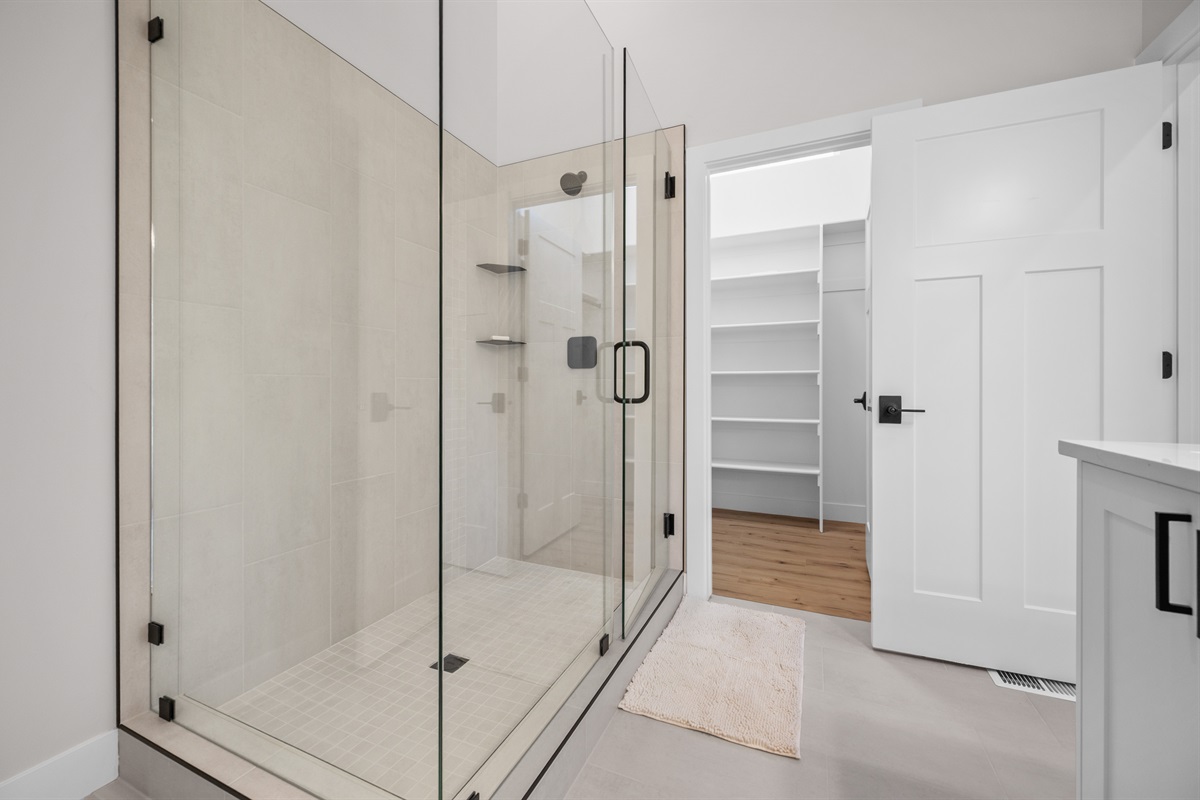 Refresh in the oversized walk-in shower, then step into the spacious custom walk-in closet.